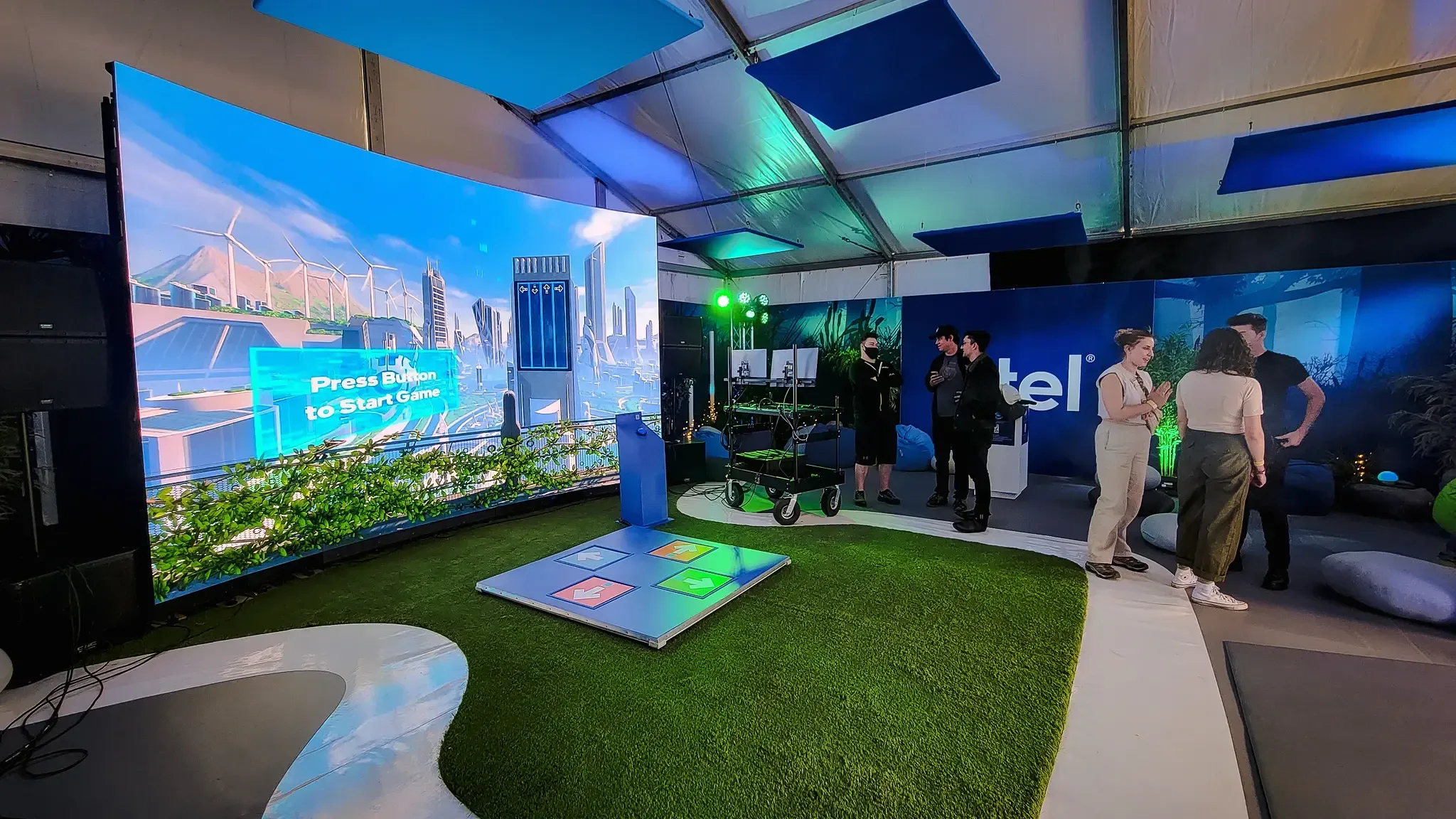 A group of people are playing a video game in a tent.