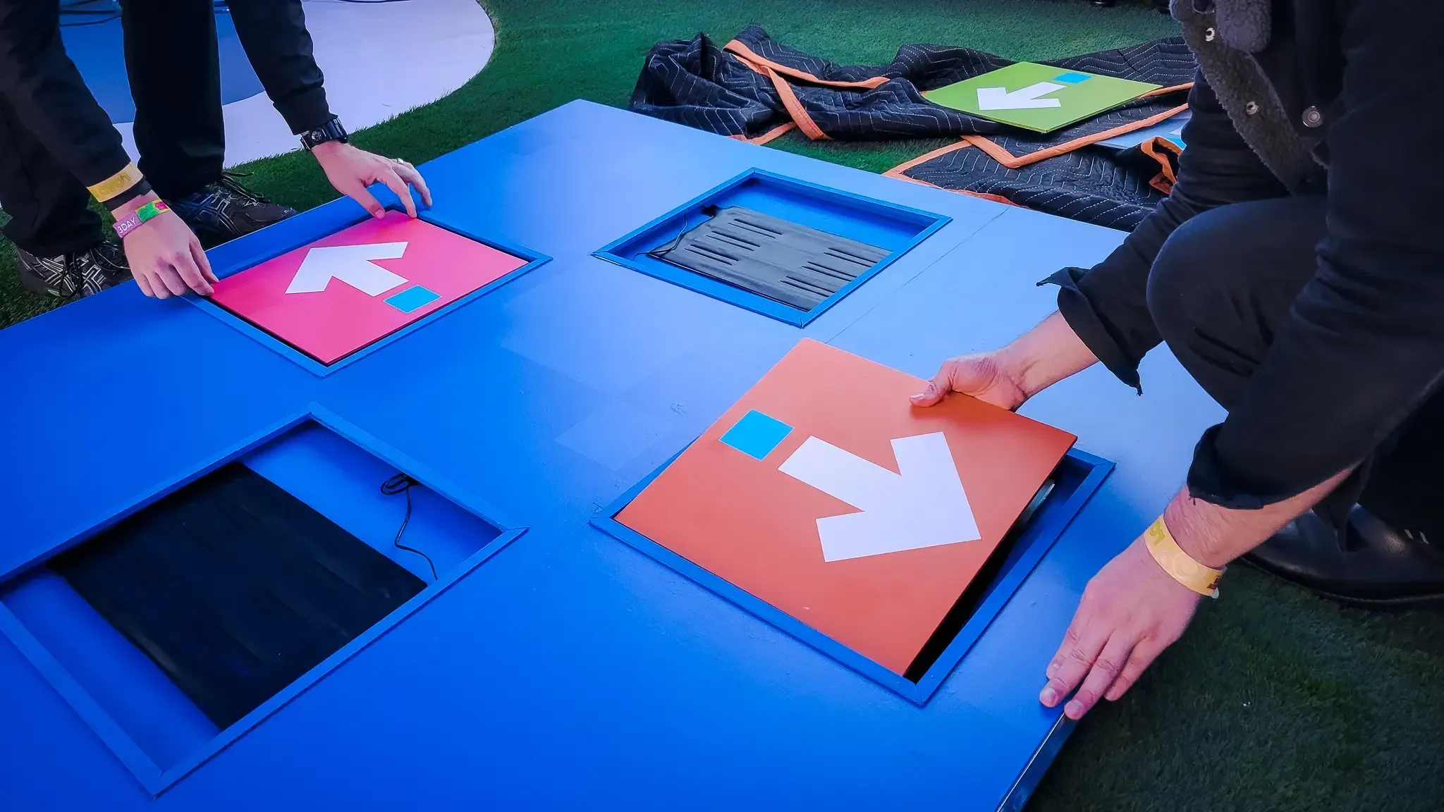 A person is holding a blue and orange button.